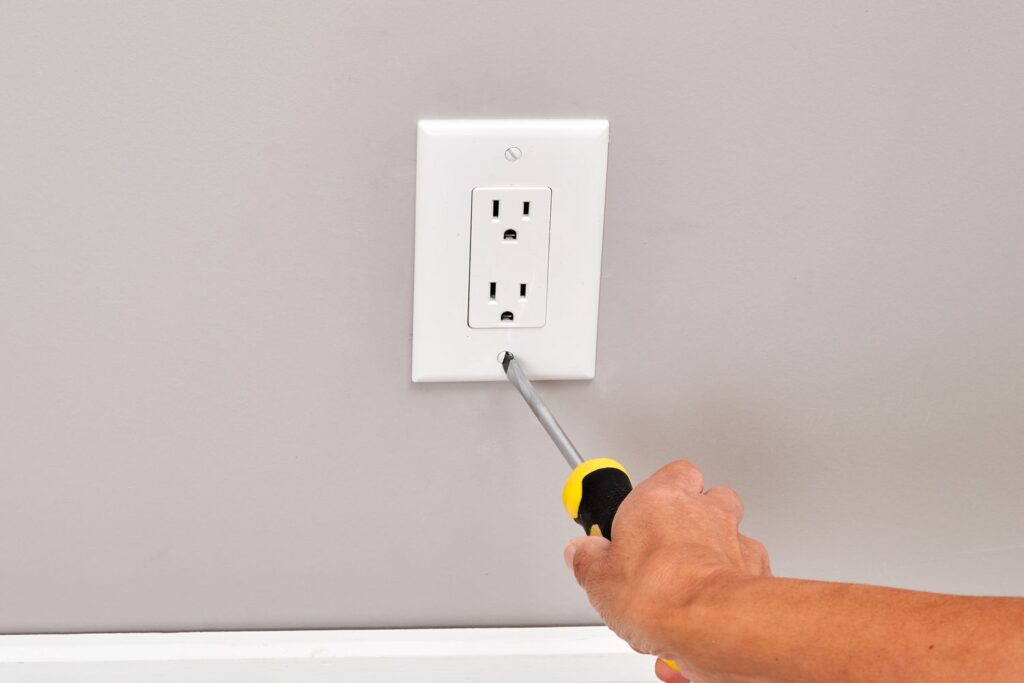 outlet feels warm after replacing outlet cover